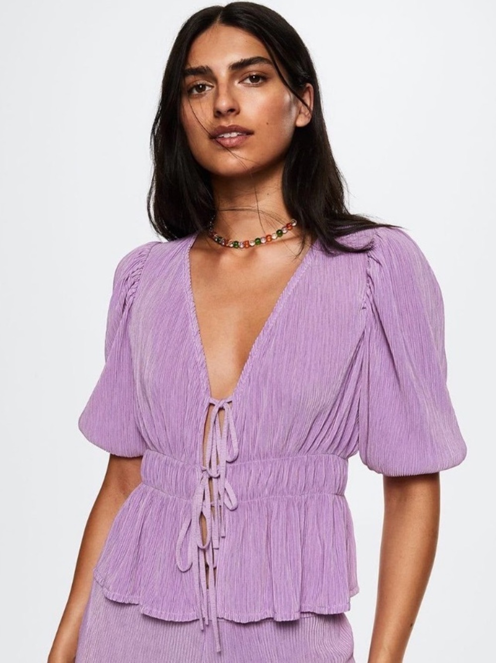 Mango plissé tie-up top w/ short puff sleeves and an elastic waist.